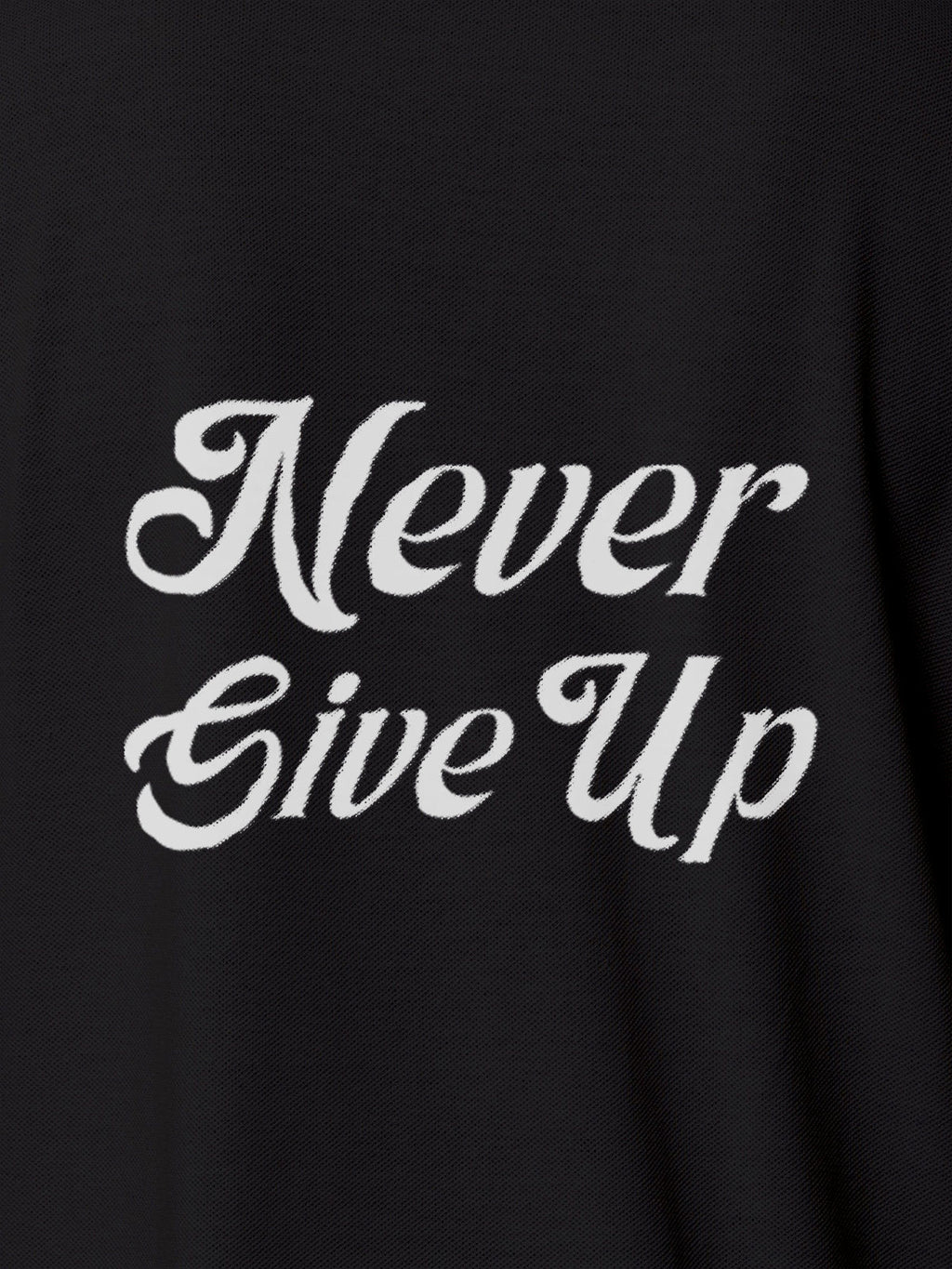 Close up of 'Never Give Up' design on Women's Dark Grey Polo T-shirt, highlighting intricate details and vibrant print.