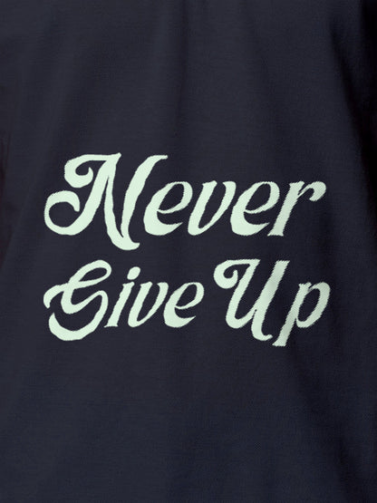 Close up of 'Never Give Up' design on Men's Navy Blue Polo T-shirt, highlighting intricate details and vibrant print.
