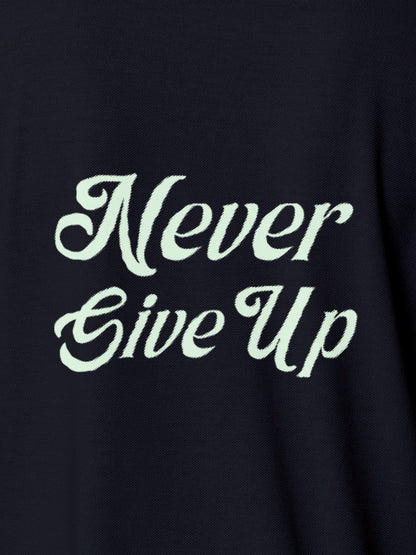 Close up of 'Never Give Up' design on Women's Navy Blue Polo T-shirt, highlighting intricate details and vibrant print.