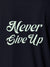 Close up of 'Never Give Up' design on Women's Navy Blue Polo T-shirt, highlighting intricate details and vibrant print.