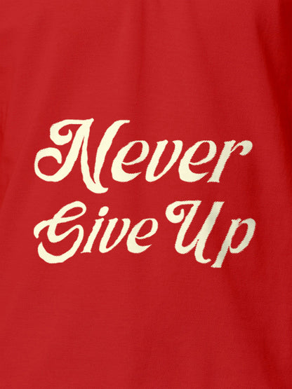 Close up of 'Never Give Up' design on Men's Red Polo T-shirt, highlighting intricate details and vibrant print.