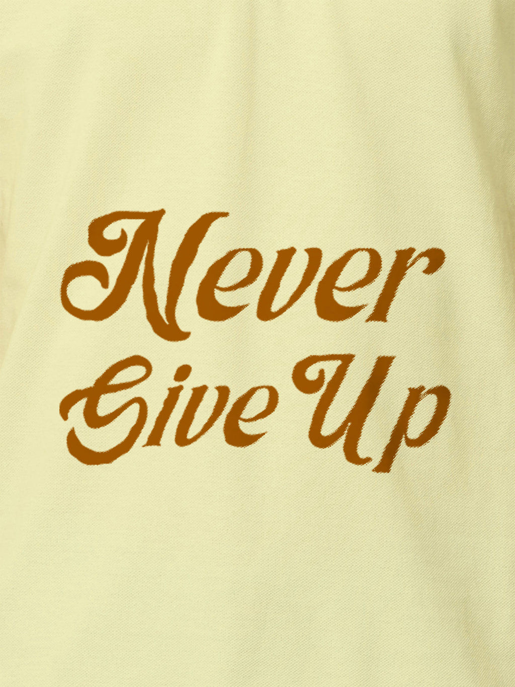 Close up of 'Never Give Up' design on Men's Yellow Polo T-shirt, highlighting intricate details and vibrant print.