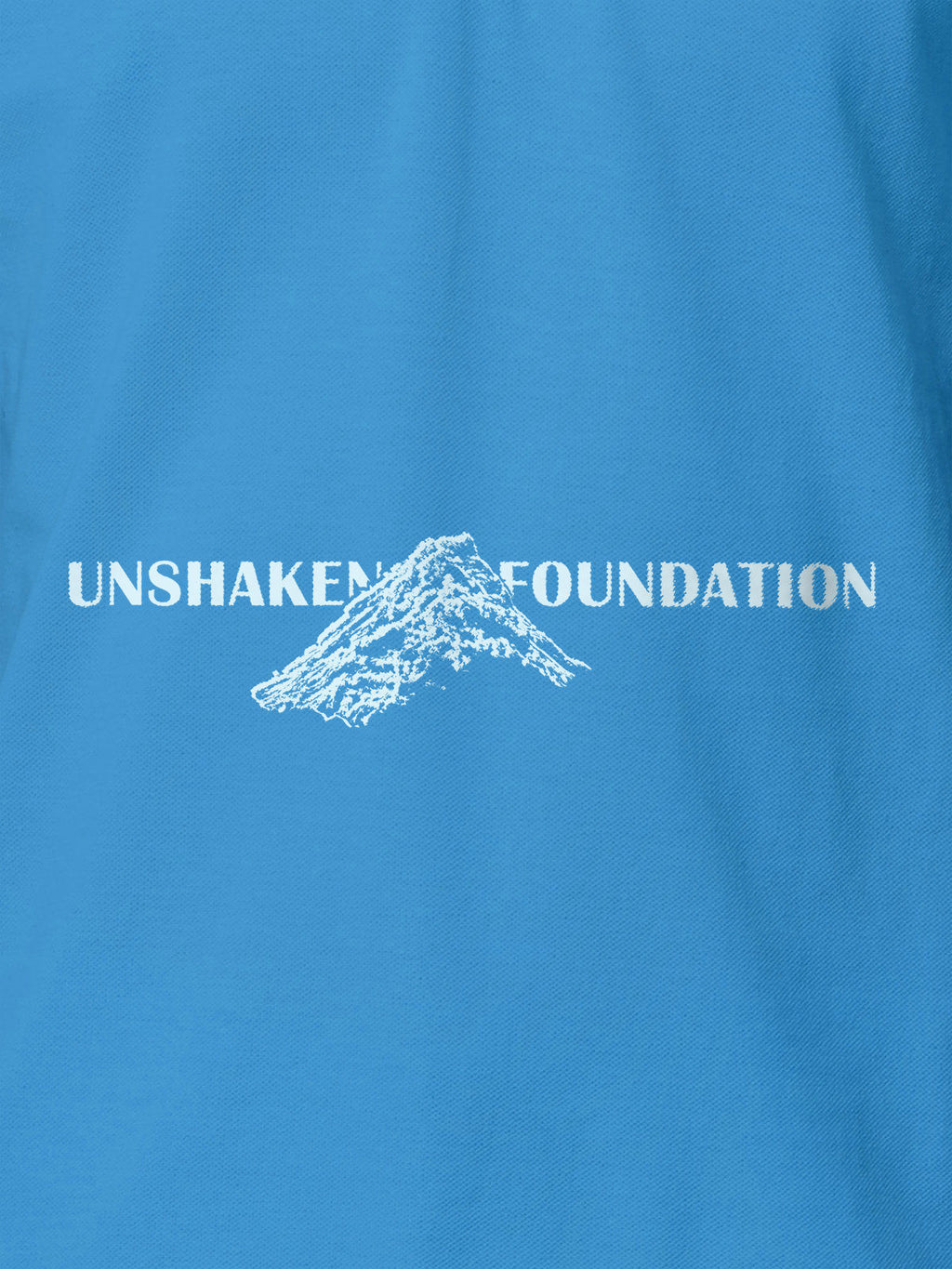 Close up of 'Unshaken Foundation' design on Women's Blue Polo T-shirt, highlighting intricate details and vibrant print.