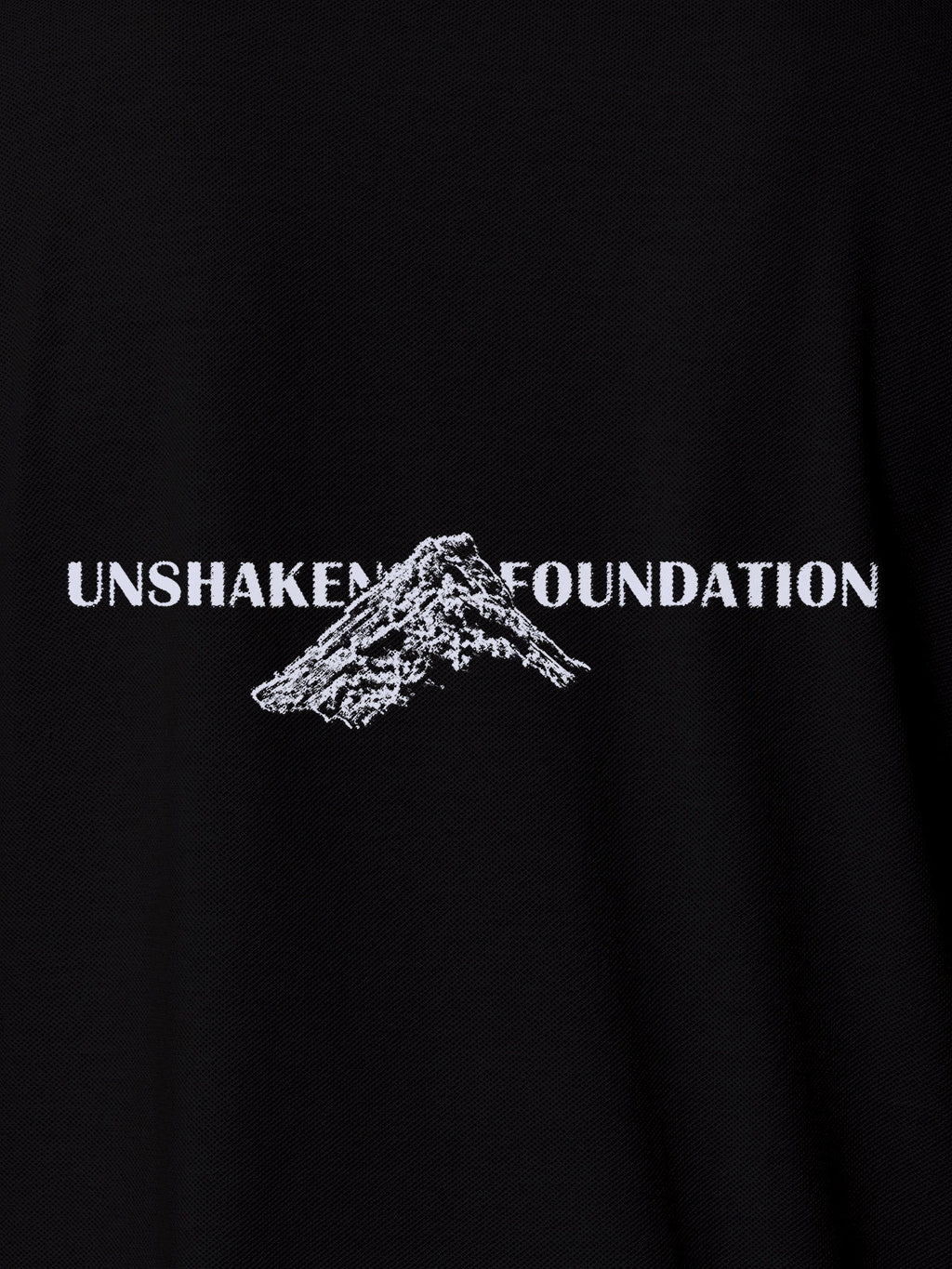 Close up of 'Unshaken Foundation' design on Men's Black Polo T-shirt, highlighting intricate details and vibrant print.
