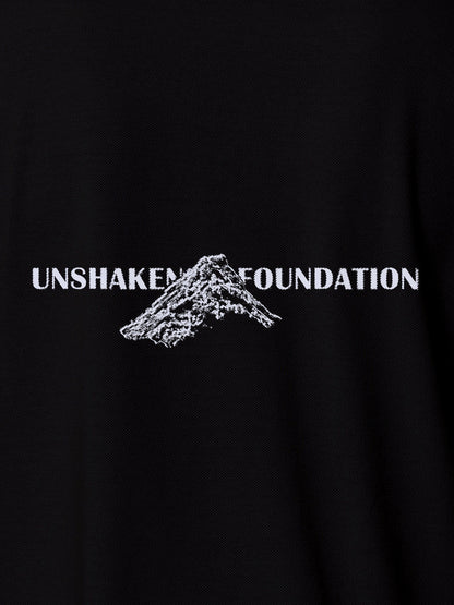 Close up of 'Unshaken Foundation' design on Men's Black Polo T-shirt, highlighting intricate details and vibrant print.