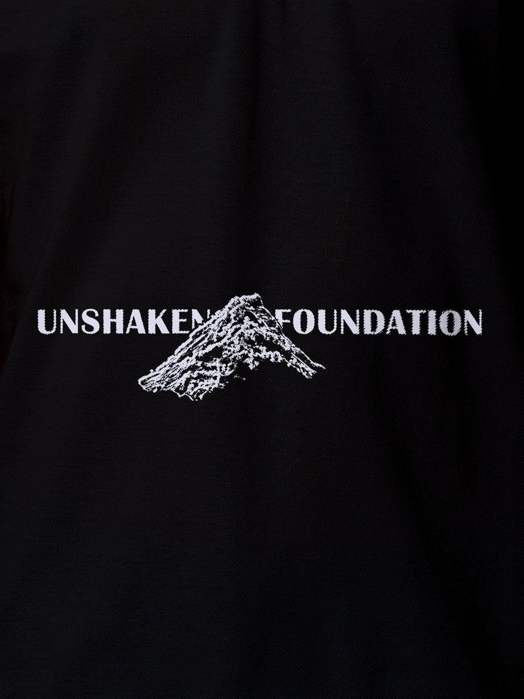 Close up of 'Unshaken Foundation' design on Women's Black Polo T-shirt, highlighting intricate details and vibrant print.
