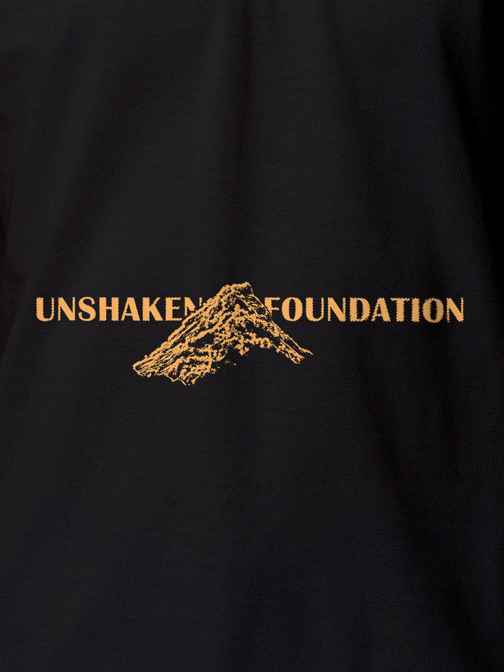 Close up of 'Unshaken Foundation' design on Women's Dark Grey Polo T-shirt, highlighting intricate details and vibrant print.