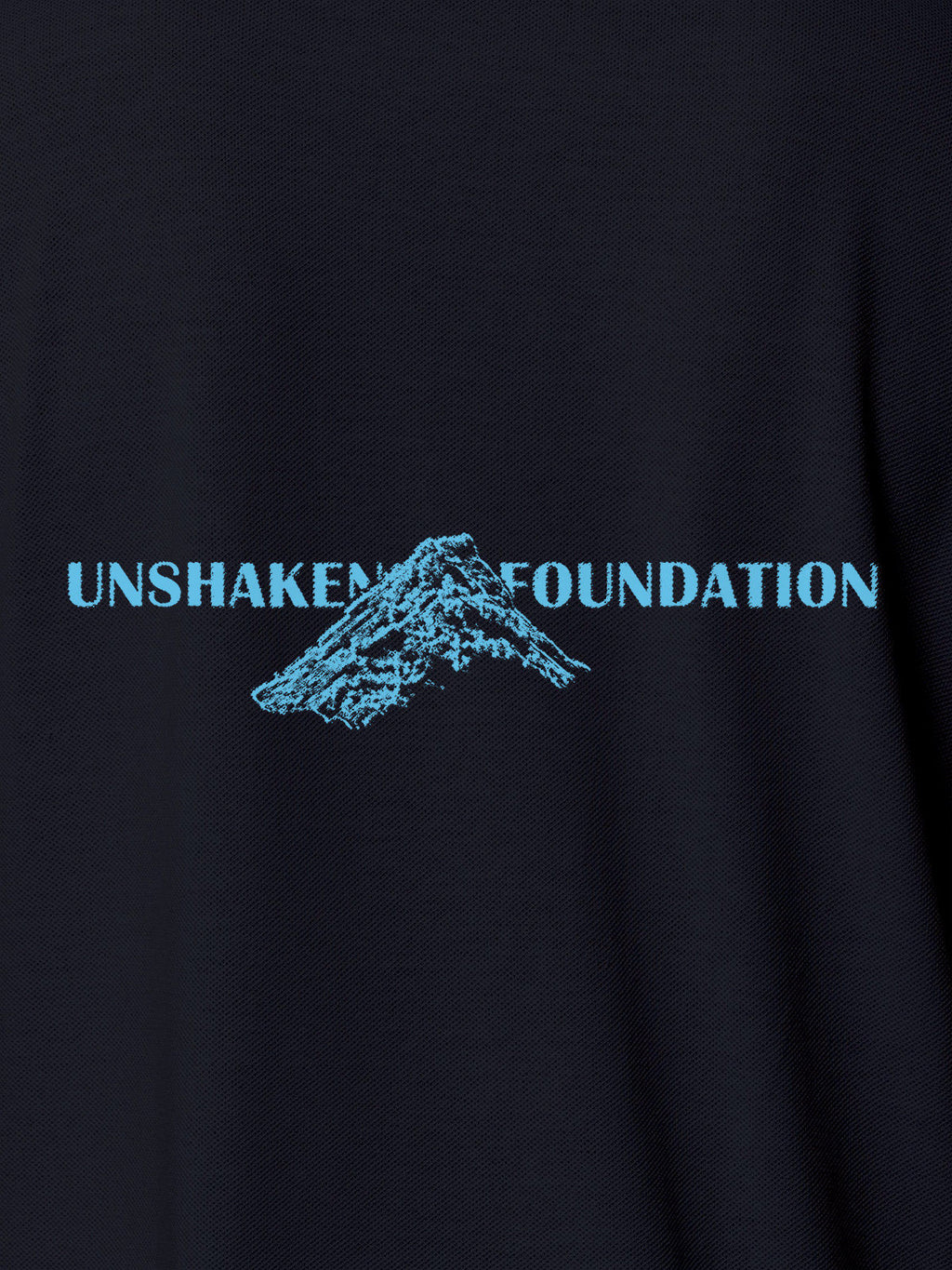 Close up of 'Unshaken Foundation' design on Men's Navy Blue Polo T-shirt, highlighting intricate details and vibrant print.
