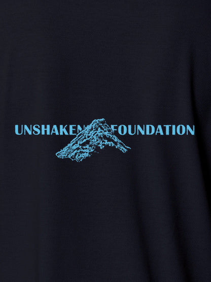 Close up of 'Unshaken Foundation' design on Men's Navy Blue Polo T-shirt, highlighting intricate details and vibrant print.