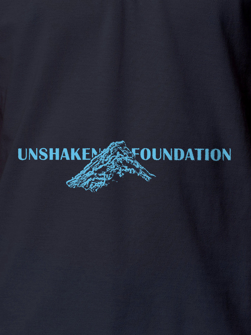 Close up of 'Unshaken Foundation' design on Women's Navy Blue Polo T-shirt, highlighting intricate details and vibrant print.