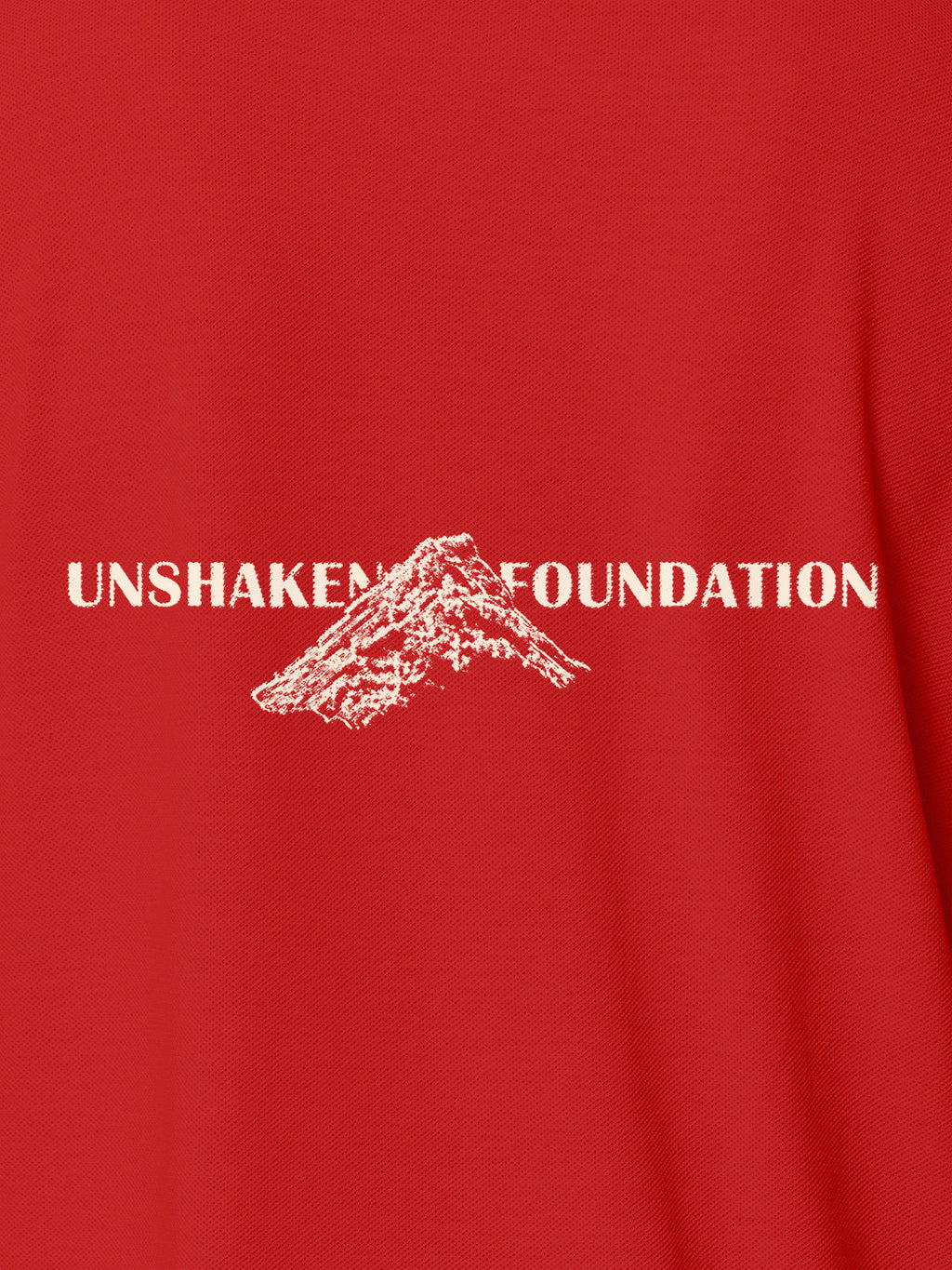 Close up of 'Unshaken Foundation' design on Men's Red Polo T-shirt, highlighting intricate details and vibrant print.
