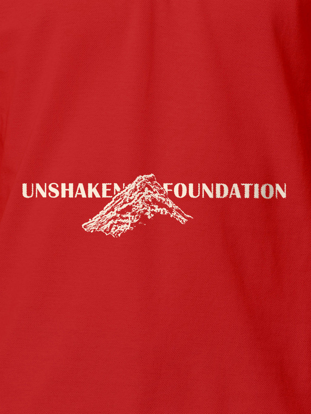Close up of 'Unshaken Foundation' design on Women's Red Polo T-shirt, highlighting intricate details and vibrant print.