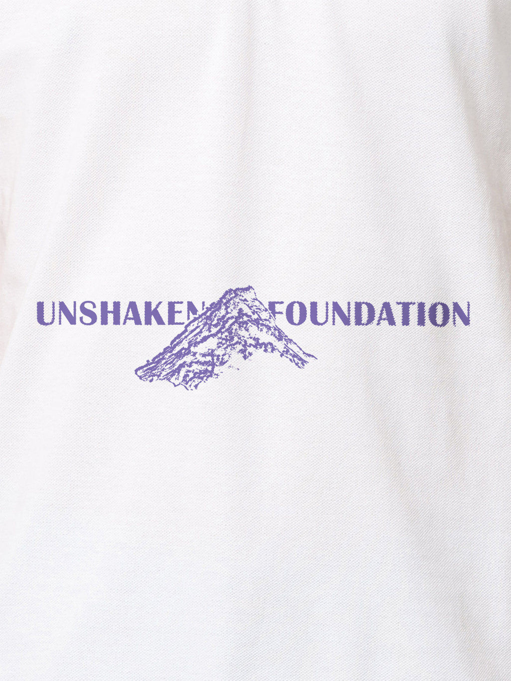 Close up of 'Unshaken Foundation' design on Women's White Polo T-shirt, highlighting intricate details and vibrant print.