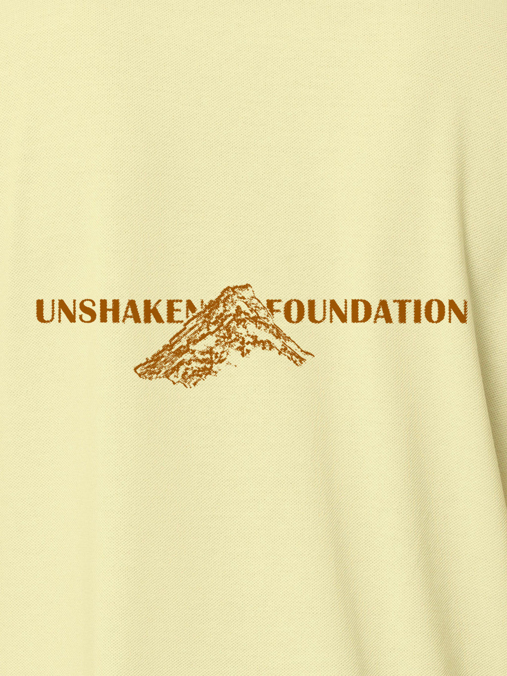 Close up of 'Unshaken Foundation' design on Men's Yellow Polo T-shirt, highlighting intricate details and vibrant print.