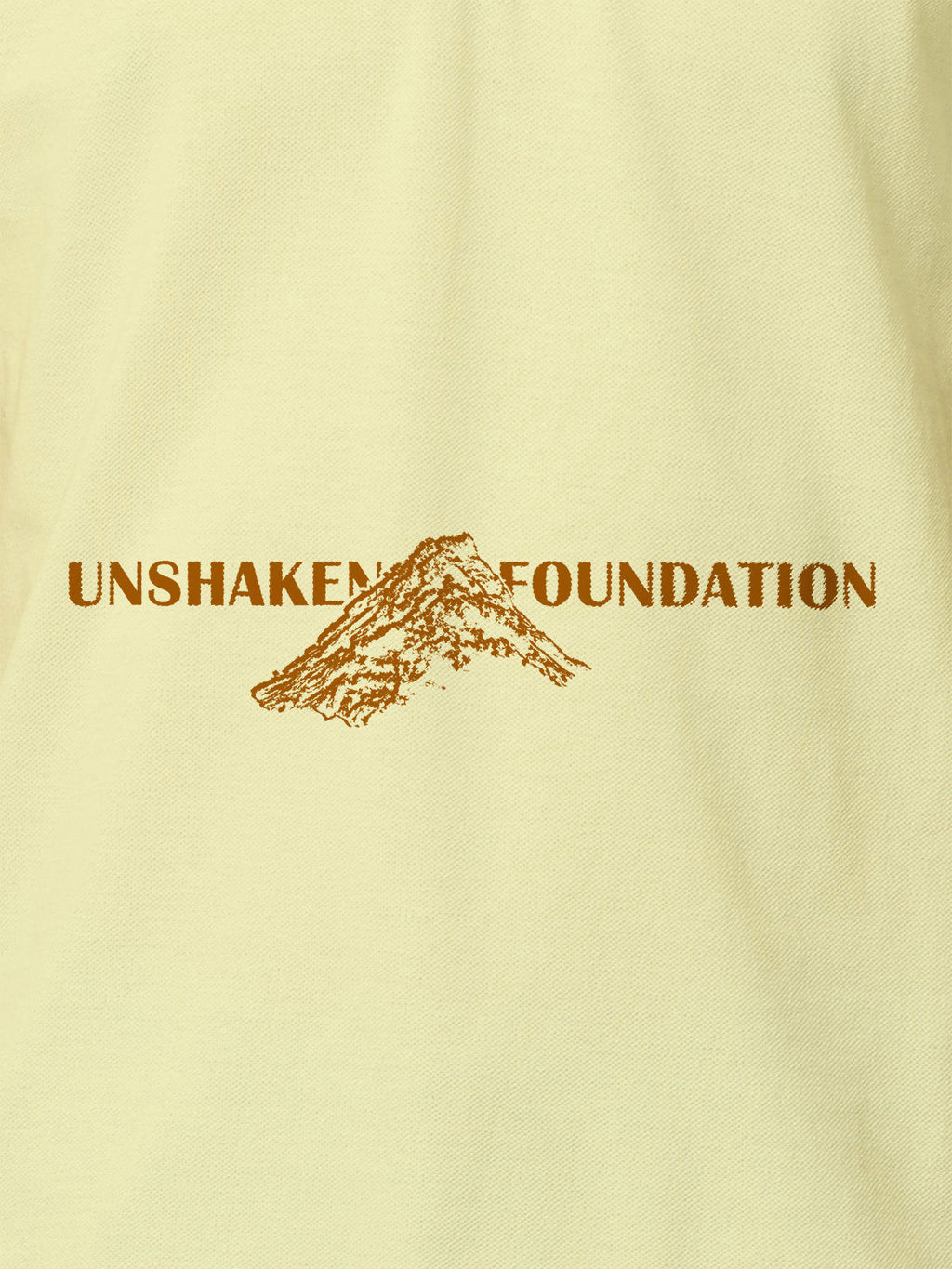 Close up of 'Unshaken Foundation' design on Women's Yellow Polo T-shirt, highlighting intricate details and vibrant print.