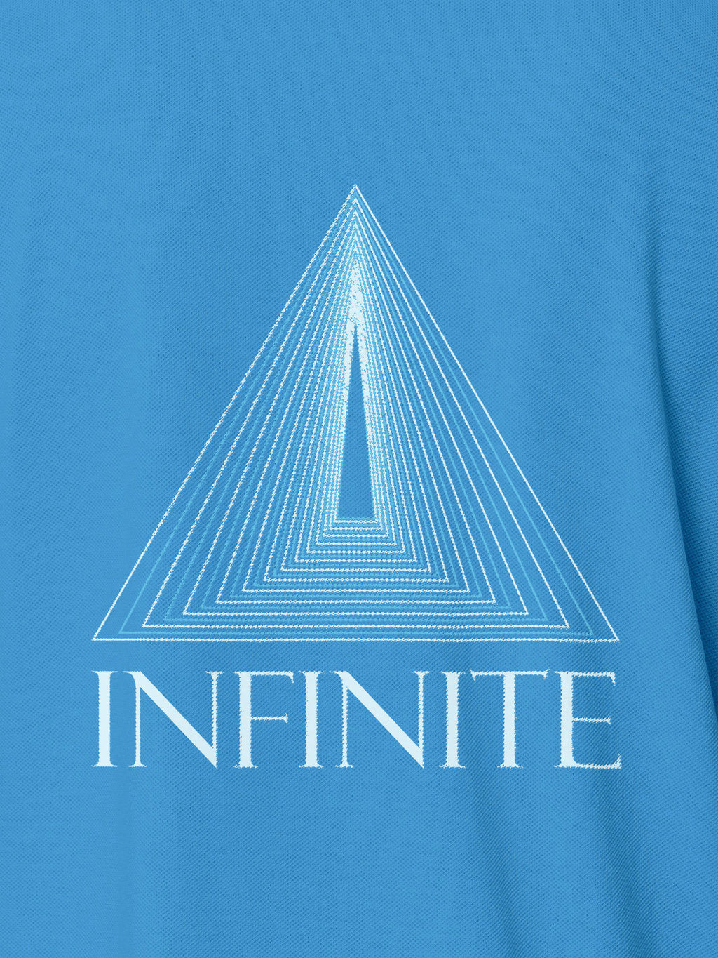 Close up of 'Go Infinite' design on Women's Blue Polo T-shirt, highlighting intricate details and vibrant print.
