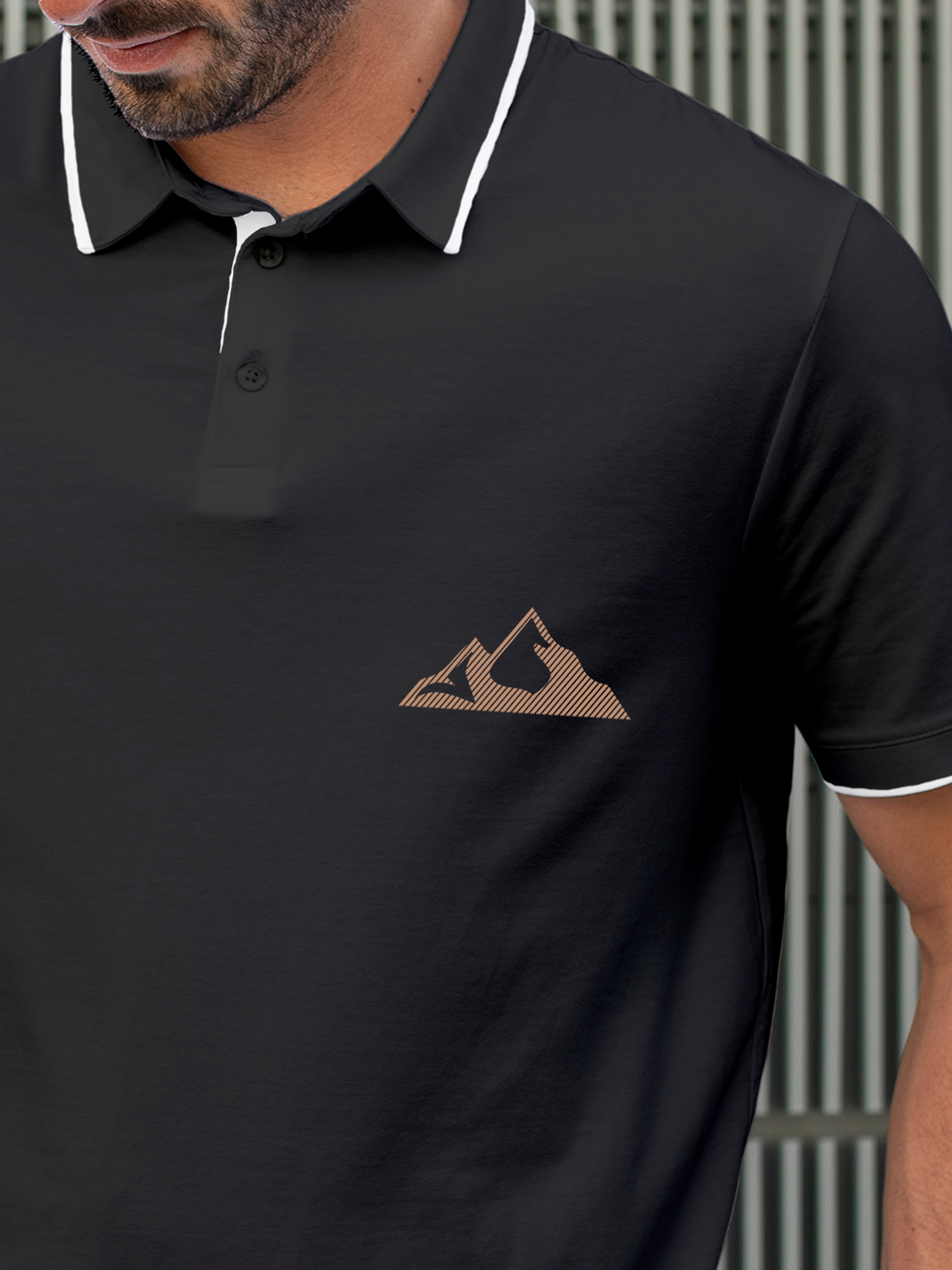 Close up of 'Grit' design on Men's Charcoal Grey Polo T-shirt, highlighting intricate details and vibrant print.