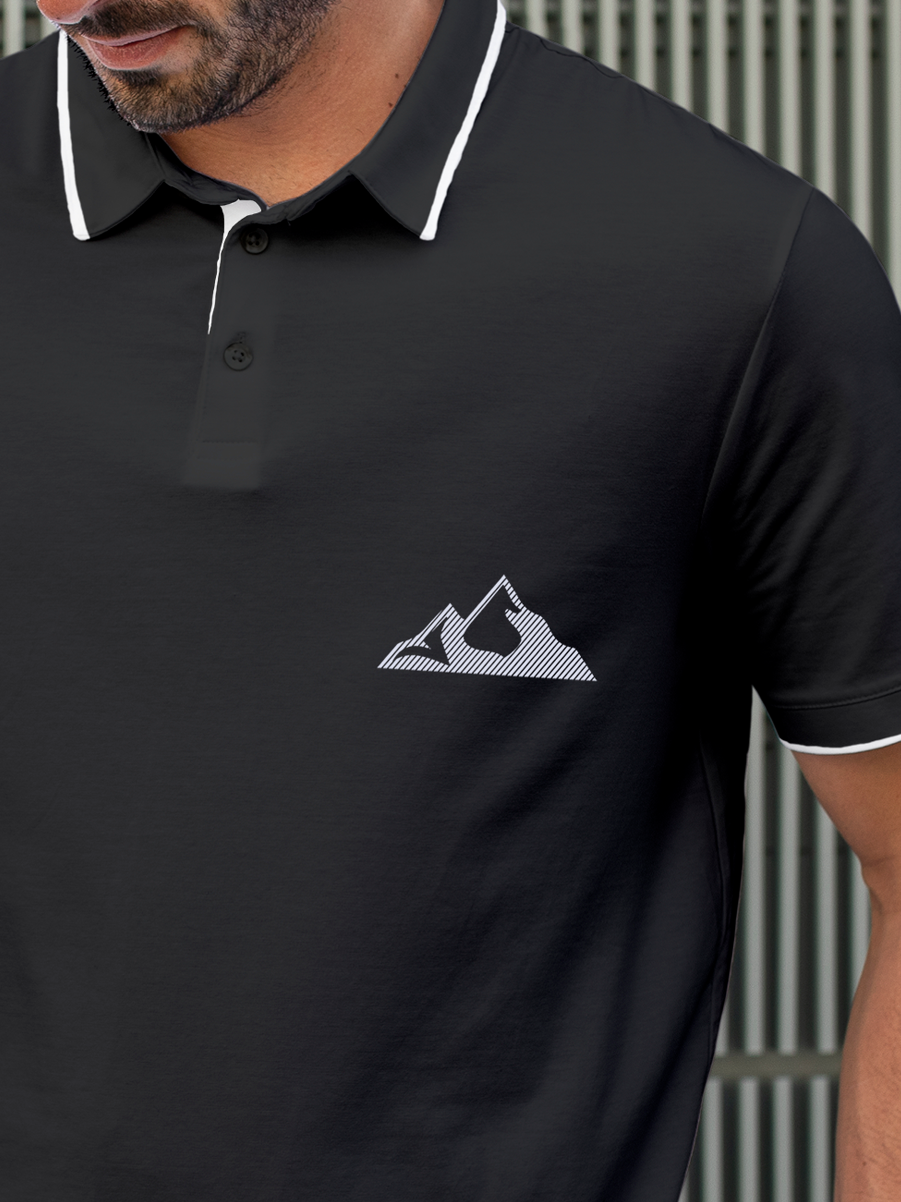 Close up of 'Grit' design on Men's Charcoal Grey Polo T-shirt, highlighting intricate details and vibrant print.