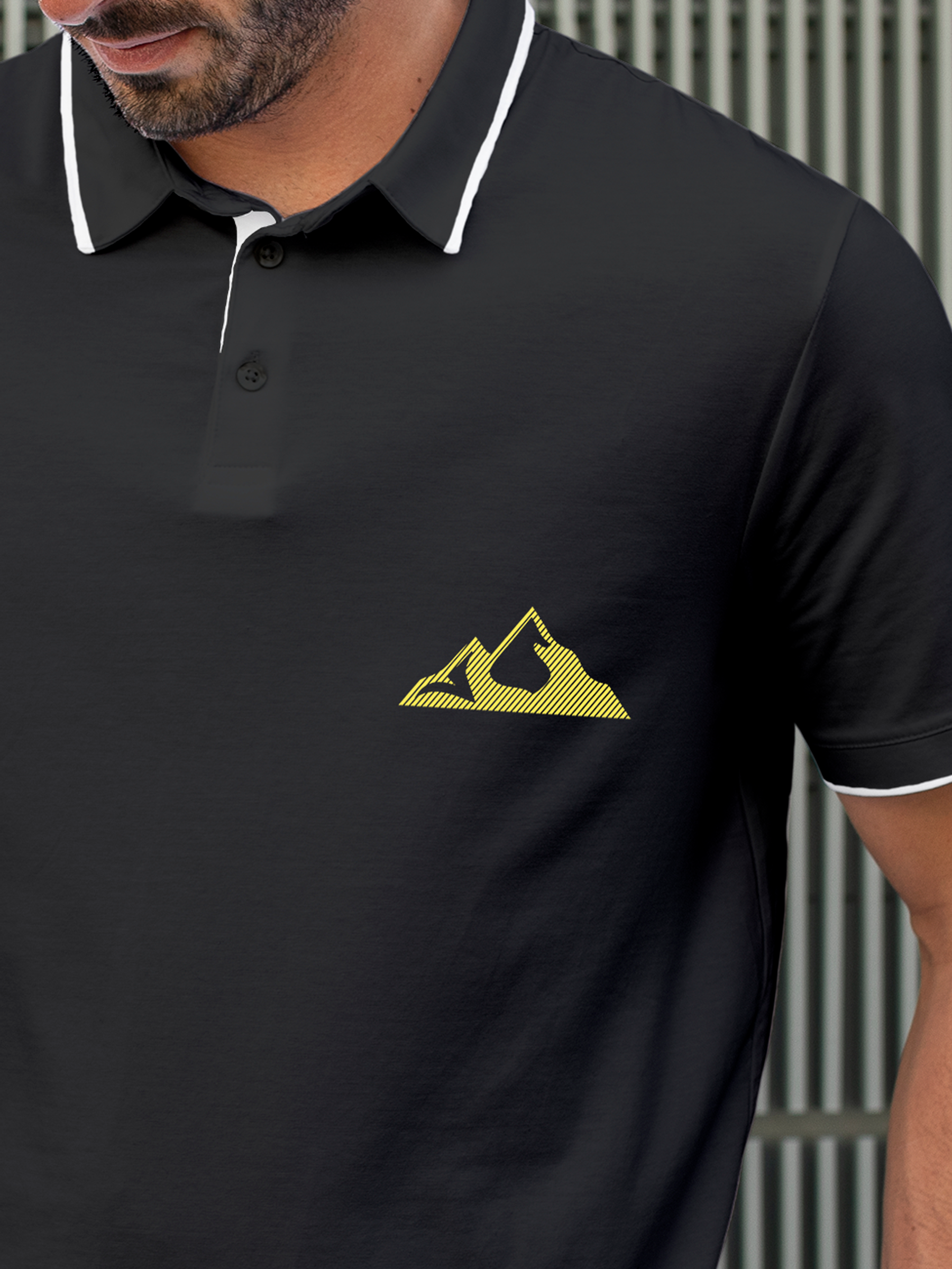 Close up of 'Grit' design on Men's Charcoal Grey Polo T-shirt, highlighting intricate details and vibrant print.