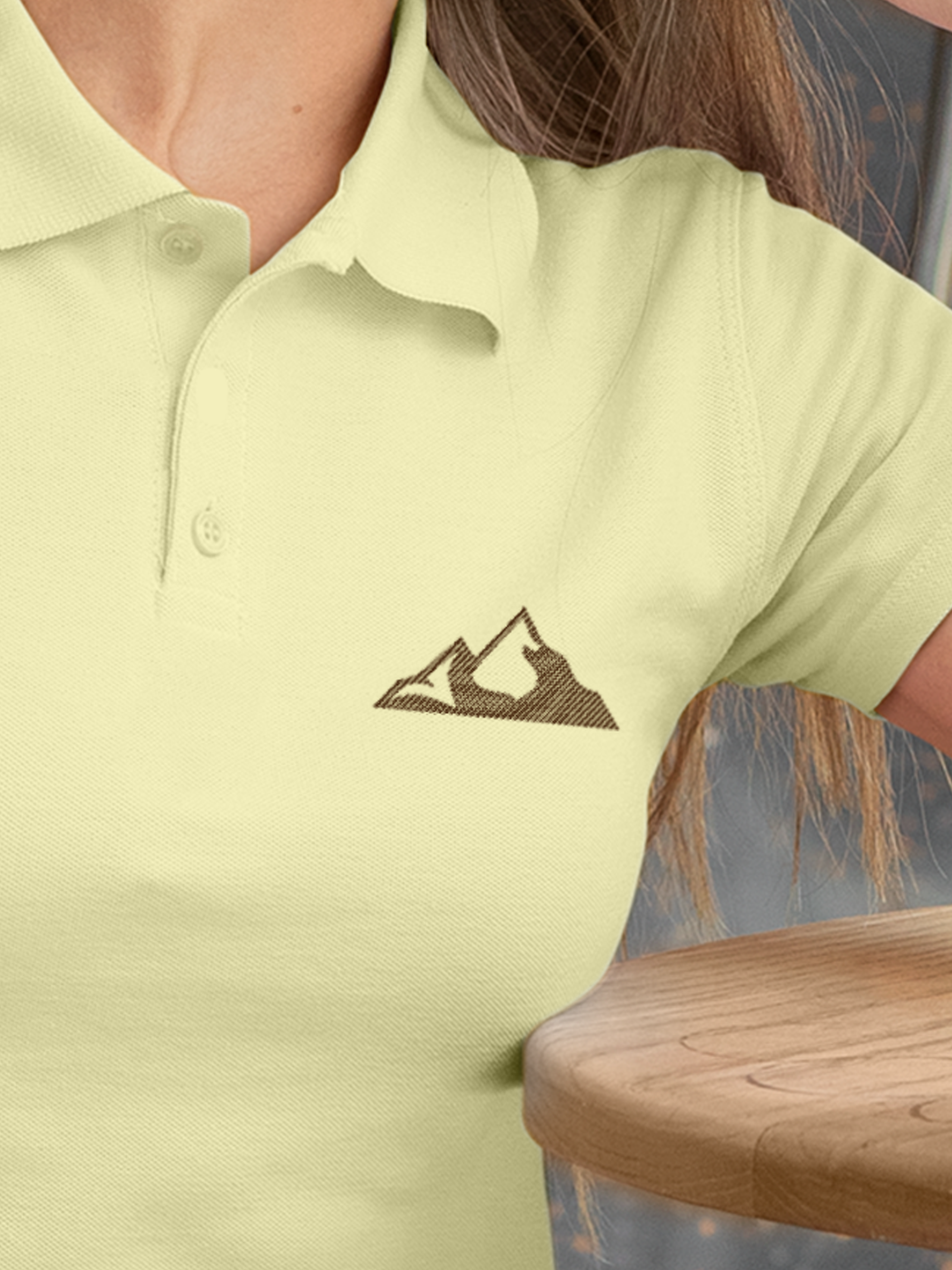 Close up of 'Grit' design on Women's Yellow Polo T-shirt, highlighting intricate details and vibrant print.