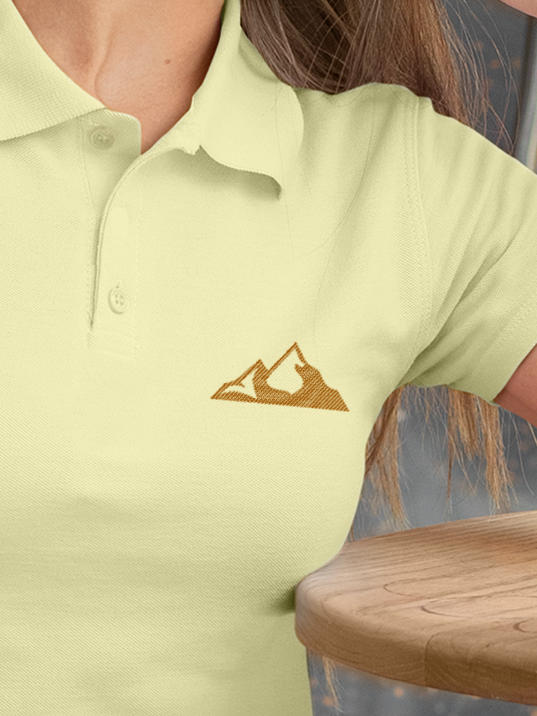 Close up of 'Grit' design on Women's Yellow Polo T-shirt, highlighting intricate details and vibrant print.