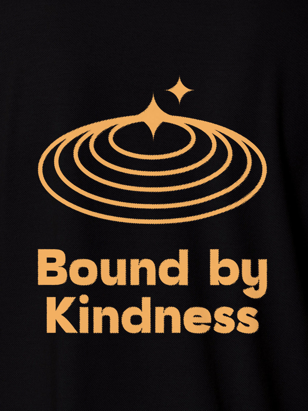 Close up of 'Bound By Kindness' design on Women's Black Polo T-shirt, highlighting intricate details and vibrant print.