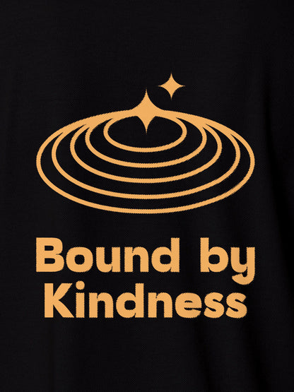 Close up of 'Bound By Kindness' design on Women's Black Polo T-shirt, highlighting intricate details and vibrant print.