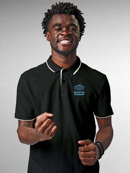 Model wearing Men's Dark Grey Polo T-shirt with 'Bound By Kindness' design, offering effortless style and premium comfort