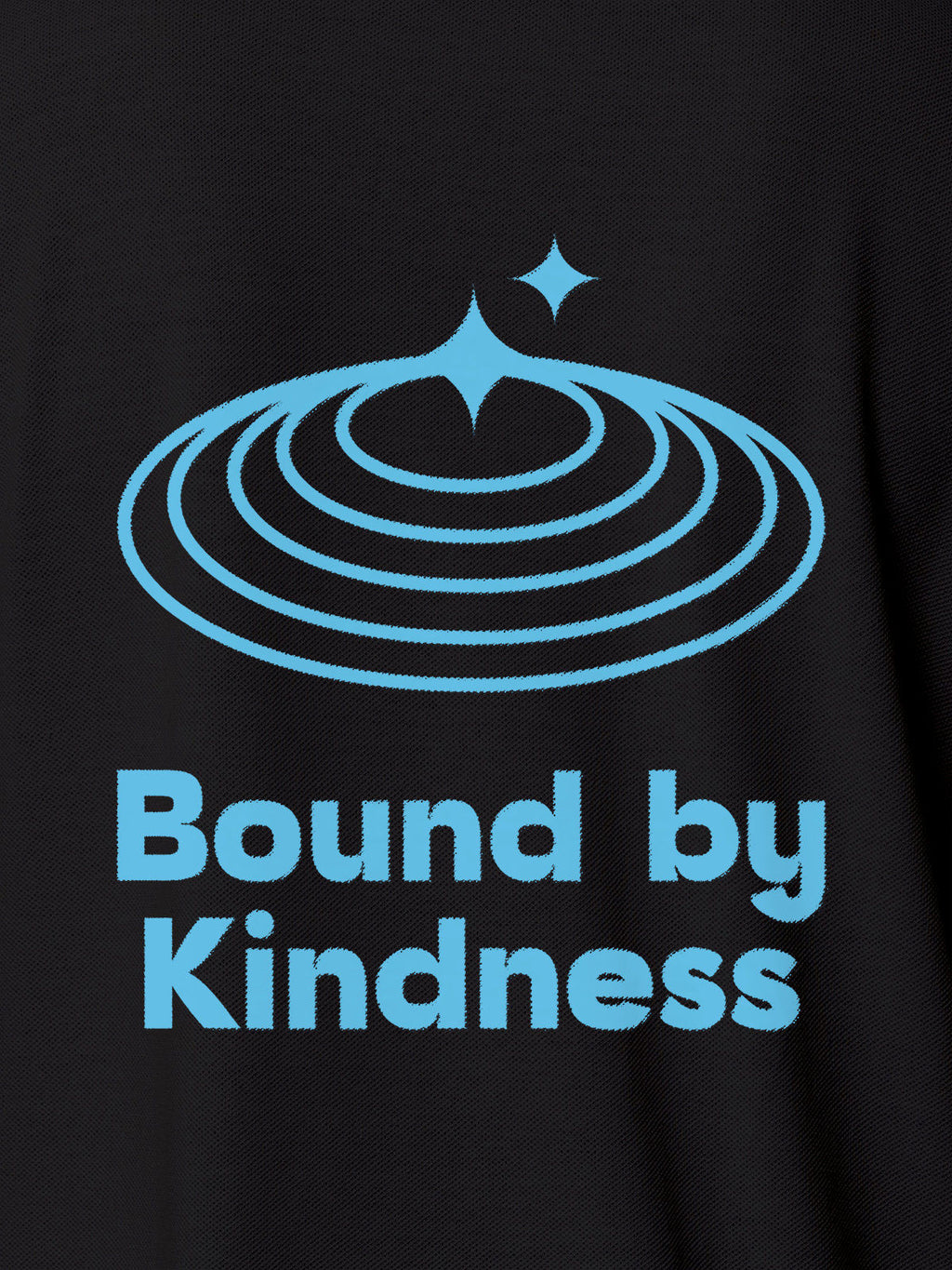 Close up of 'Bound By Kindness' design on Women's Dark Grey Polo T-shirt, highlighting intricate details and vibrant print.