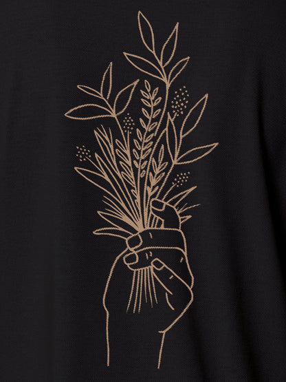 Close up of 'Love and Joy' design on Men's Dark Grey Polo T-shirt, highlighting intricate details and vibrant print.