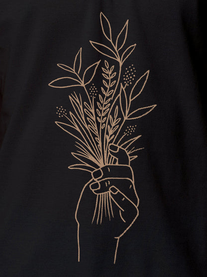 Close up of 'Love and Joy' design on Women's Dark Grey Polo T-shirt, highlighting intricate details and vibrant print.