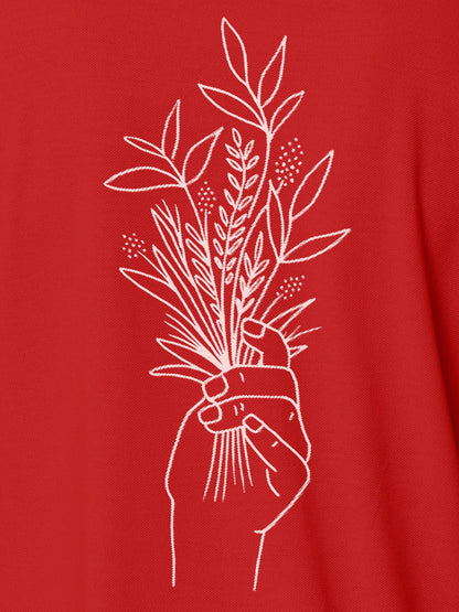 Close up of 'Love and Joy' design on Men's Red Polo T-shirt, highlighting intricate details and vibrant print.