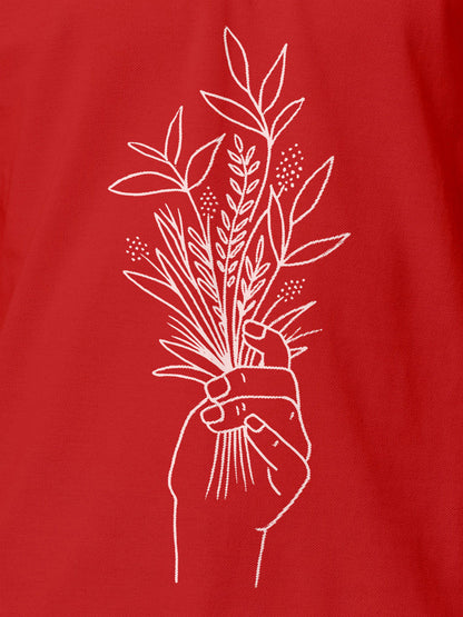Close up of 'Love and Joy' design on Women's Red Polo T-shirt, highlighting intricate details and vibrant print.