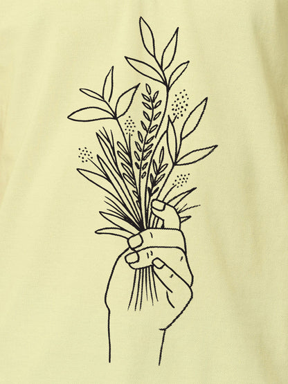 Close up of 'Love and Joy' design on Women's Yellow Polo T-shirt, highlighting intricate details and vibrant print.