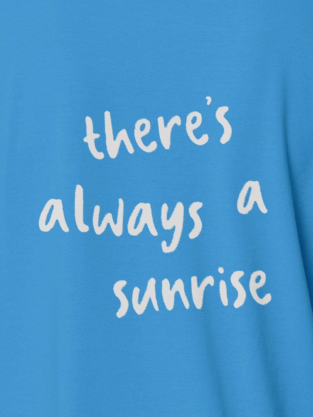 Close up of 'There's Always a Sunrise' design on Women's Blue Polo T-shirt, highlighting intricate details and vibrant print.