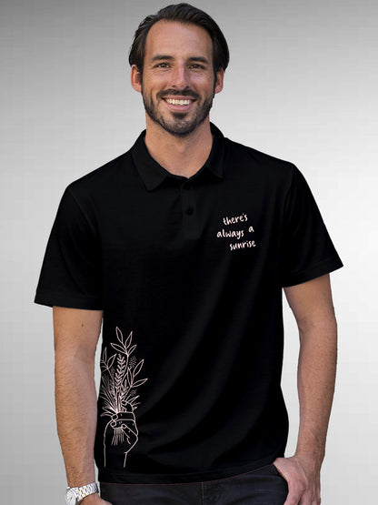 Model wearing Men's Black Polo T-shirt with 'There's Always a Sunrise' design, offering effortless style and premium comfort