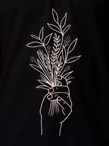 Close up of another 'There's Always a Sunrise' design on Men's Black Collar T-shirt, highlighting the vibrant print.