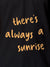 Close up of 'There's Always a Sunrise' design on Men's Dark Grey Polo T-shirt, highlighting intricate details and vibrant print.