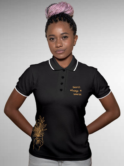 Model wearing Women's Dark Grey Polo T-shirt with 'There's Always a Sunrise' design, offering effortless style and premium comfort