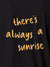 Close up of 'There's Always a Sunrise' design on Women's Dark Grey Polo T-shirt, highlighting intricate details and vibrant print.