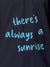 Close up of 'There's Always a Sunrise' design on Men's Navy Blue Polo T-shirt, highlighting intricate details and vibrant print.