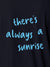 Close up of 'There's Always a Sunrise' design on Women's Navy Blue Polo T-shirt, highlighting intricate details and vibrant print.
