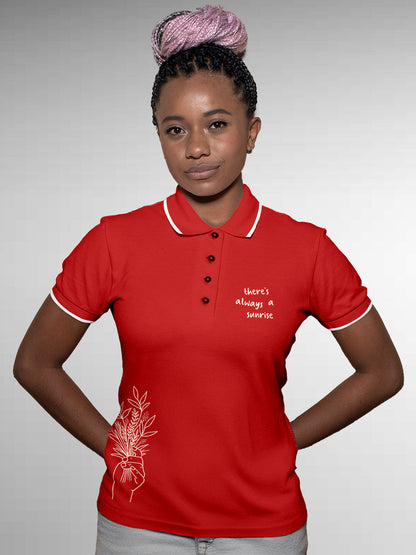 Model wearing Women's Red Polo T-shirt with 'There's Always a Sunrise' design, offering effortless style and premium comfort