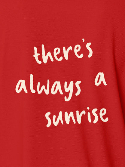 Close up of 'There's Always a Sunrise' design on Women's Red Polo T-shirt, highlighting intricate details and vibrant print.