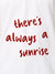 Close up of 'There's Always a Sunrise' design on Men's White Polo T-shirt, highlighting intricate details and vibrant print.