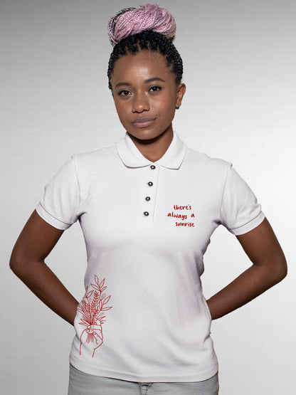 Model wearing Women's White Polo T-shirt with 'There's Always a Sunrise' design, offering effortless style and premium comfort