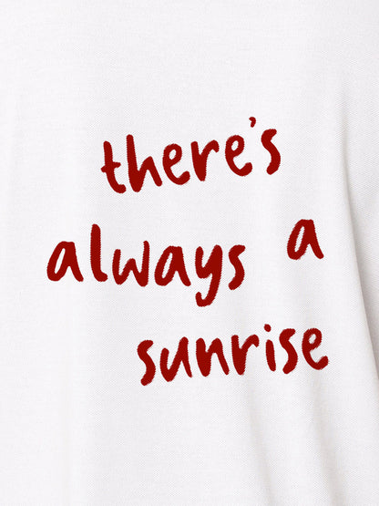 Close up of 'There's Always a Sunrise' design on Women's White Polo T-shirt, highlighting intricate details and vibrant print.