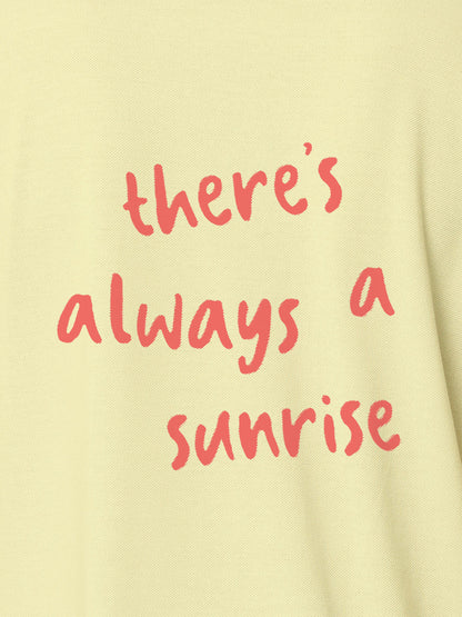 Close up of 'There's Always a Sunrise' design on Women's Yellow Polo T-shirt, highlighting intricate details and vibrant print.