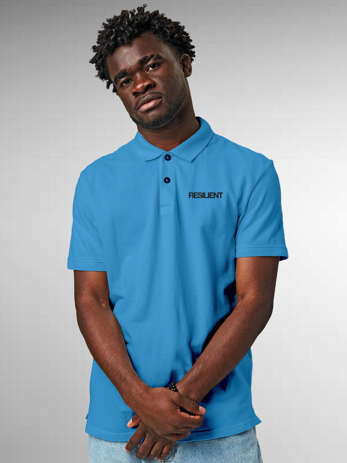 Model wearing Men's Blue Polo T-shirt with 'Resilient' design, offering effortless style and premium comfort