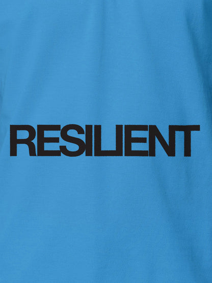 Close up of 'Resilient' design on Women's Blue Polo T-shirt, highlighting intricate details and vibrant print.